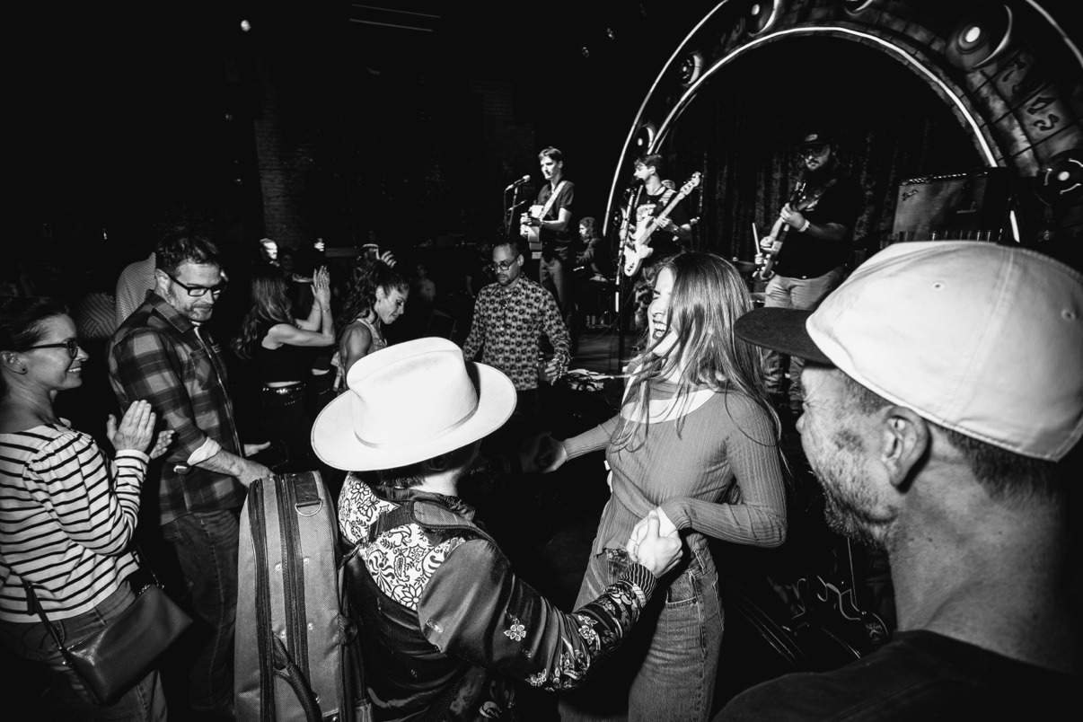 Crowd dancing while Jake performs onstage