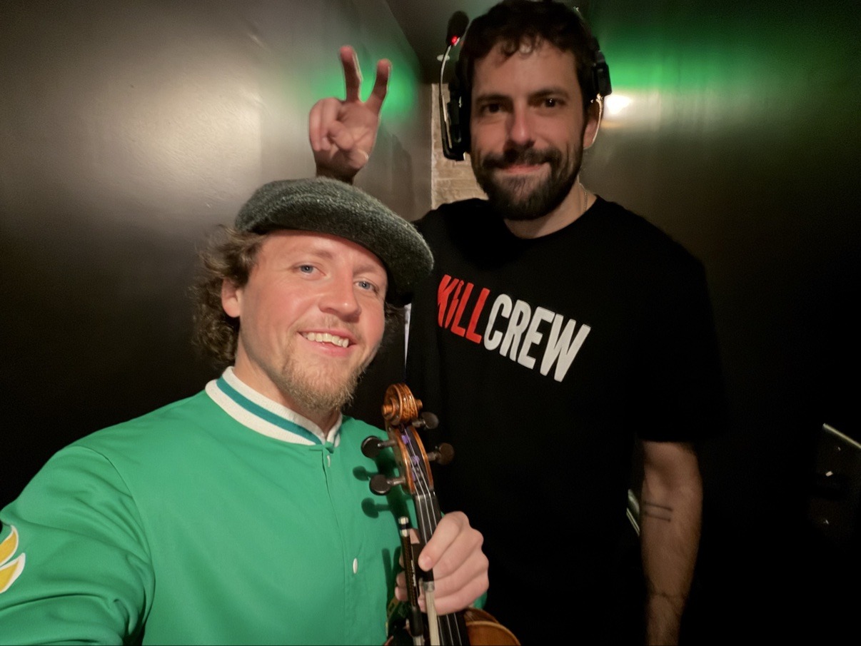 Jake Kennedy with a Kill Tony crew member backstage
