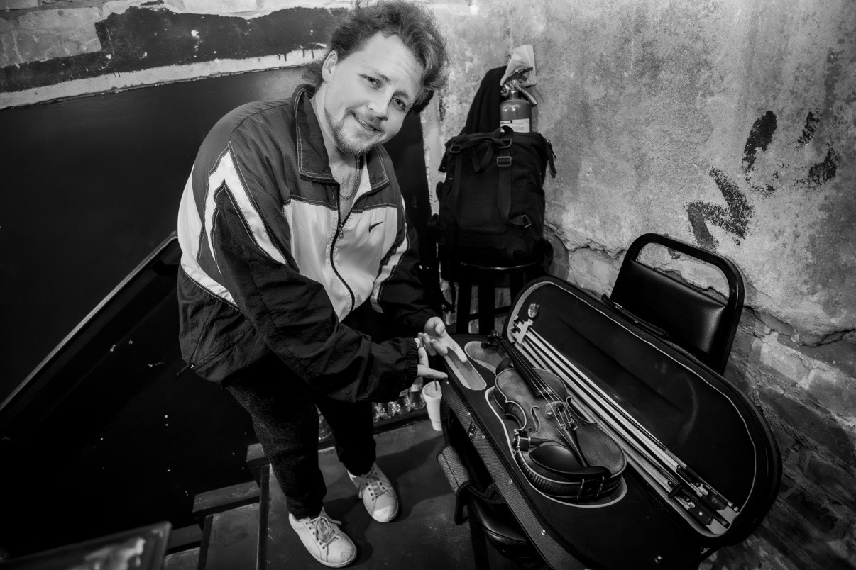 Jake Kennedy backstage with his open violin case